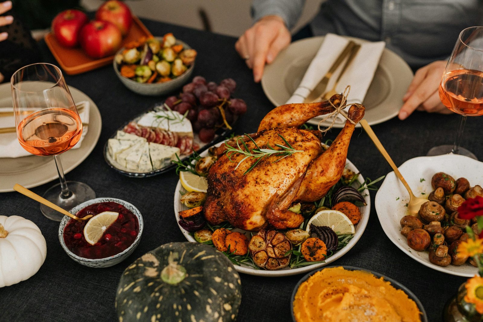 A delicious Thanksgiving dinner spread with roasted chicken, sides, and wine.